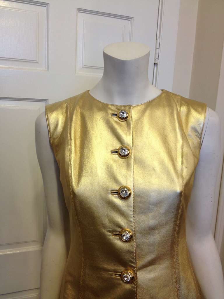 All that glitters really is gold with this YSL gold leather top!  Expertly tailored to fit every curve of the body, this piece will flatter any figure.  Large crystal and gold buttons run down the front for closure.  This top is simply fabulous, fit