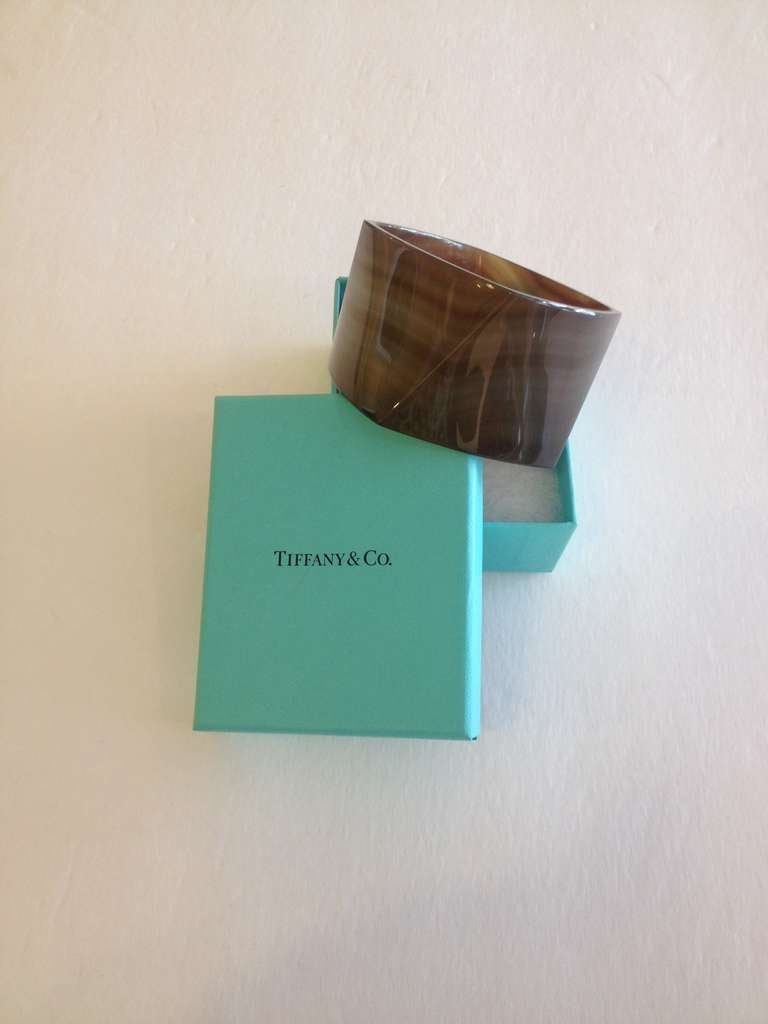 This incredible bracelet is from Tiffany & Co.’s Frank Gehry collection. The famed architect designed a collection for Tiffany in the same instantly recognizable style as his beautiful buildings. The banded agate Torque bangke is a subtle study in