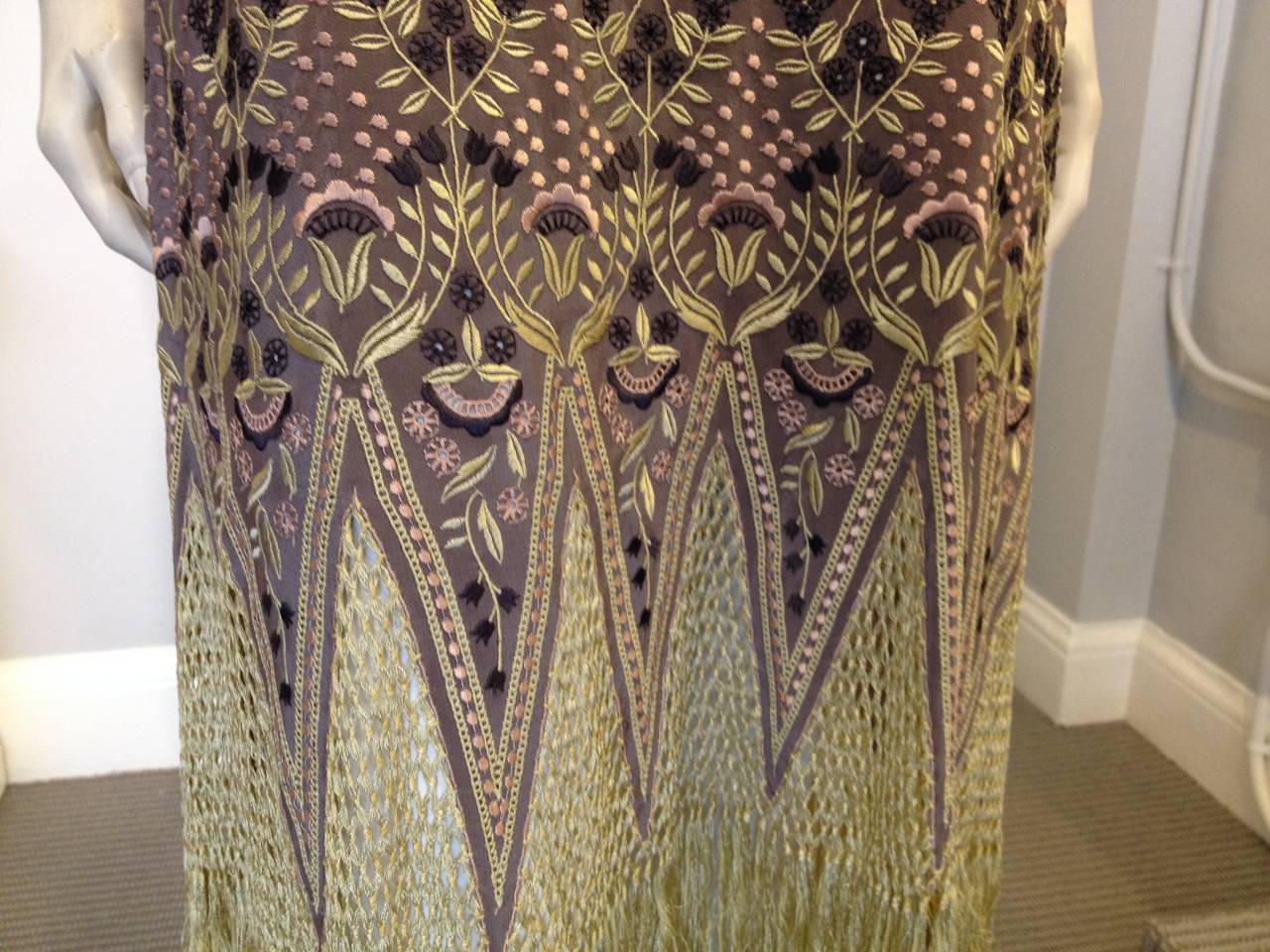 Live your art deco dreams! This Chloe piece is intricate and elaborate, and beautifully crafted. A soft dusty amethyst silk embroidered with blush dots forms the body of the dress, becoming more ornate towards the hem - at the knees it features a