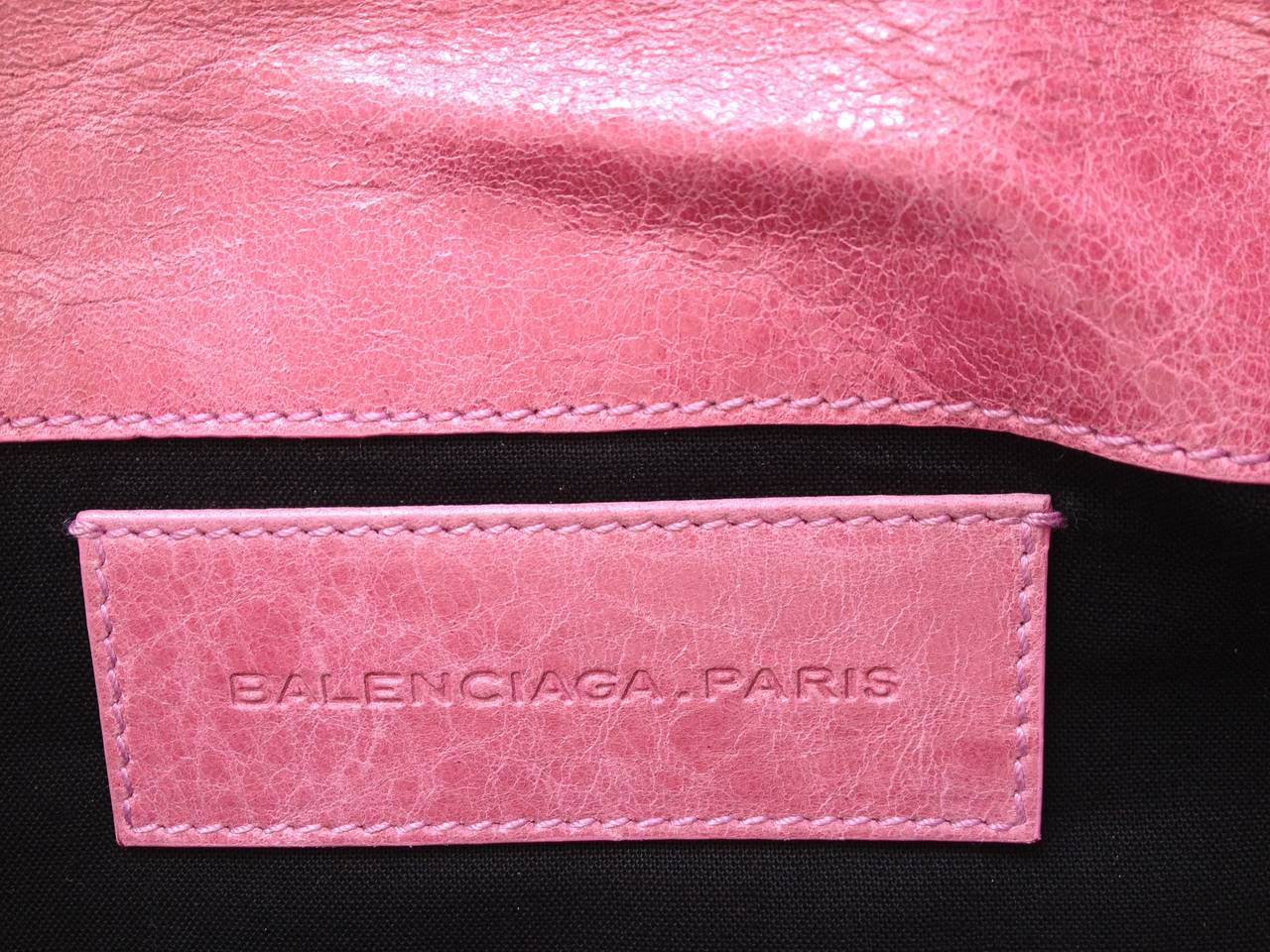 The most wonferful peony pink makes this Balenciaga so much fun! This Giant Envelope clutch features yellow gold hardware with the classic zippers and cross-hatched studs. Deceptively spacious, it  features four different pouches - one that zips