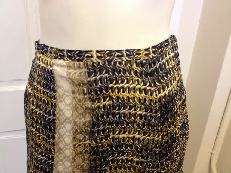 Peter Pilotto's vision embraces both new and classic perspectives on elegance. Otherworldly prints combine with soft sculptural shapes for a unique and unmistakeable style.  This partially pleated skirt has a chain link print in grays and yellowish