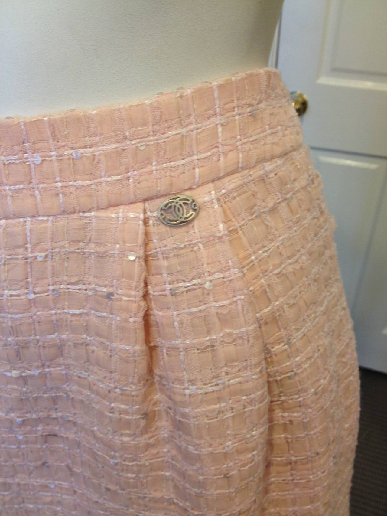 The perfect thing for someone sweet, feminine, and fashionable - this skirt in an ultra soft baby pink tweed is so Chanel. The little knife pleats at the hips add just a tiny flare from the high waistband, while the hem is trimmed with a band of