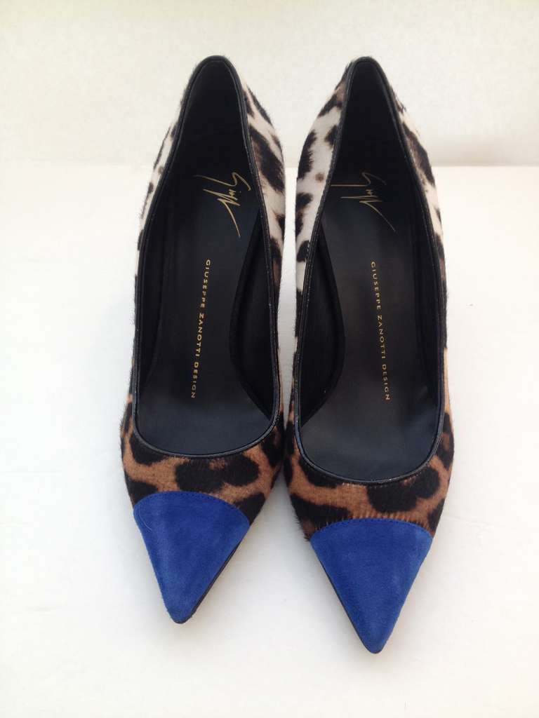 This gorgeous leopard printed pony hair pump from Giuseppe Zanotti  features a contrasting blue capped pointed toe and a black suede covered stiletto heel. The leopard print has ombre coloring for an even more unique color contrast.  The 3 inch heel