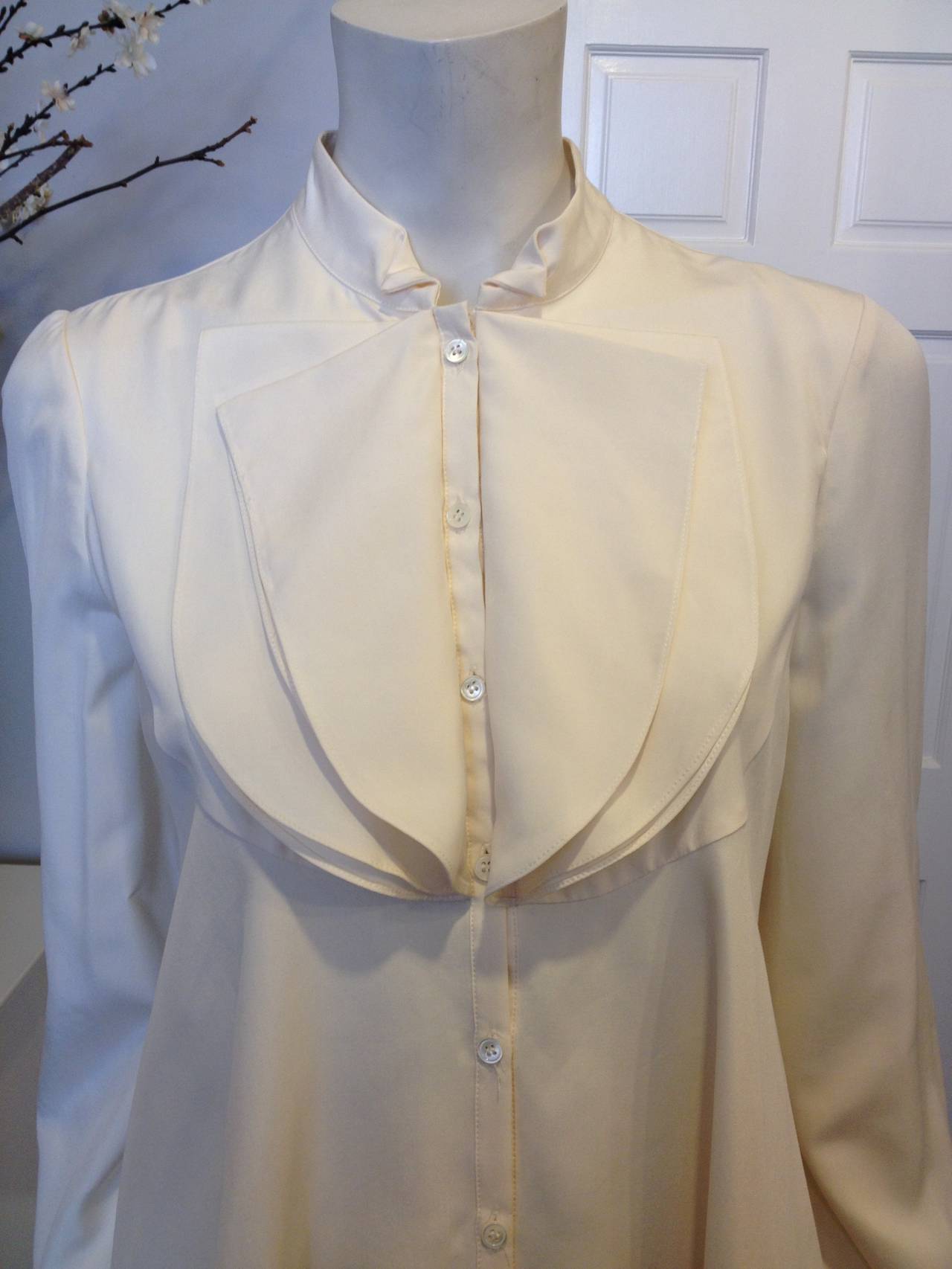 Thematically British references are often parts of the Alexander McQueen aesthetic, and this hip grazing blouse feels inspired by both Francis Drake and Victorian ladies. Four semicircular slips of fabric at the high collar create a dramatic ruffle,