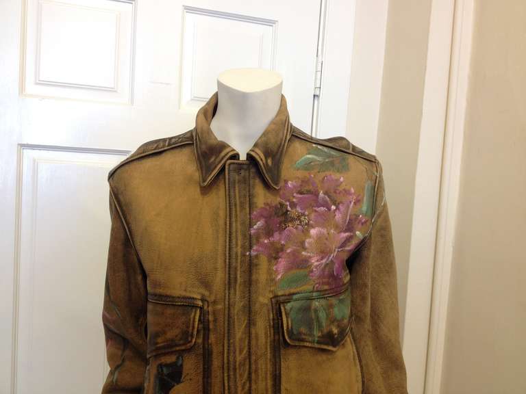 This jacket is a work in progress. With delicately rendered painted blossoms emerging from the shoulder and across the back, it's a piece that looks well-loved and full of history - the broken-in, super-soft leather and the realistic aviator style