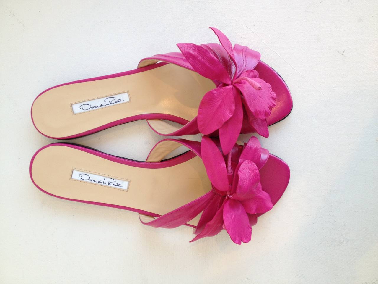 These beautiful Oscar de la Renta slides will transport you somewhere tropical, whether you're vacationing in Saint Lucia this summer or staying home. The fuchsia leather bands that cross the toes are shaped like leaves, and the center is decorated