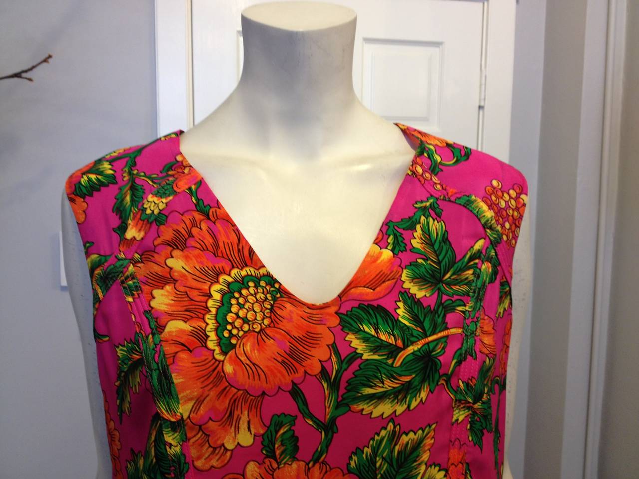 Bright and  vibrant, the carnation pattern decorating this Marni blouse is perfect for adding a splash of color to your look. Warm magenta, lively persimmon orange, and verdant green leaves contrast to create the perfect blend of color. Cut with