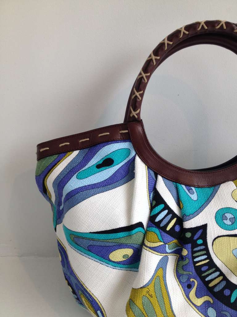 This bag is a necessity for any fan of Pucci and a great piece for anyone who appreciates the classic psychedelic design - with a bright, vibrant pattern rendered in cool toned teal, blues, lime, and navy on white, this bag is perfect for summer.