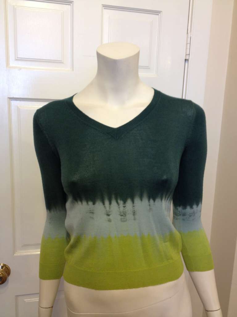 Dip yourself in Prada! Tie-dyed stripes of emerald, electric blue, and lime cross this gorgeous little cropped top. This sweater does tie-dye in a high-fashion way!