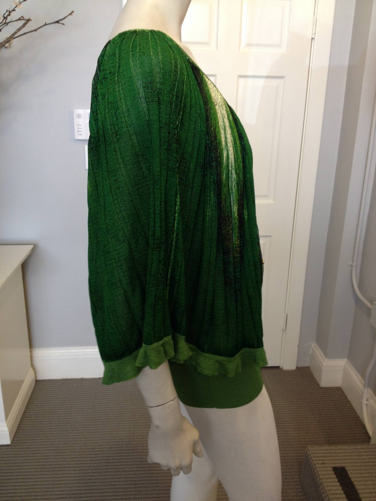 Beautifully variegated greens ranging from celery to emerald and interspersed with cream and black create a most attractive effect on this dramatic summer Cavalli top. The cut is striking - the neckline scoops in the front and back, and the sleeves