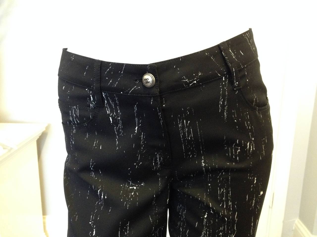 Easy but unusual - these Chanel pants are just ideal to replace your jeans any day of the week. Crisp black fabric is splattered with a subtle but interesting pattern of fine white lines. The cut is skinny and cropped to an ankle length, featuring