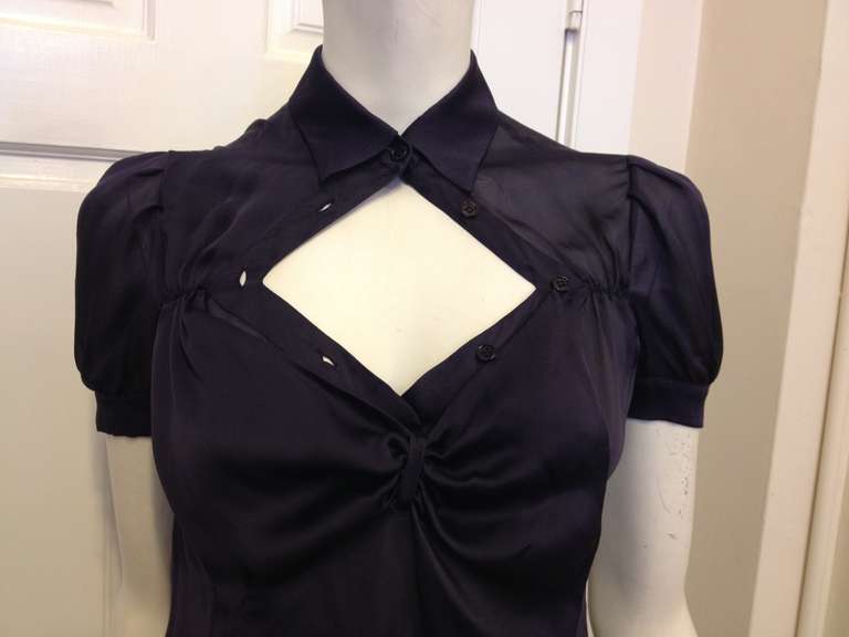 Shine like a diamond in this beautiful Prada top! The cut is dramatic and sexy but in a new and unexpected way, the perfect blouse for a night out. With a little point collar, a bustier-like drape that buttons over the front, and slightly puffed-out