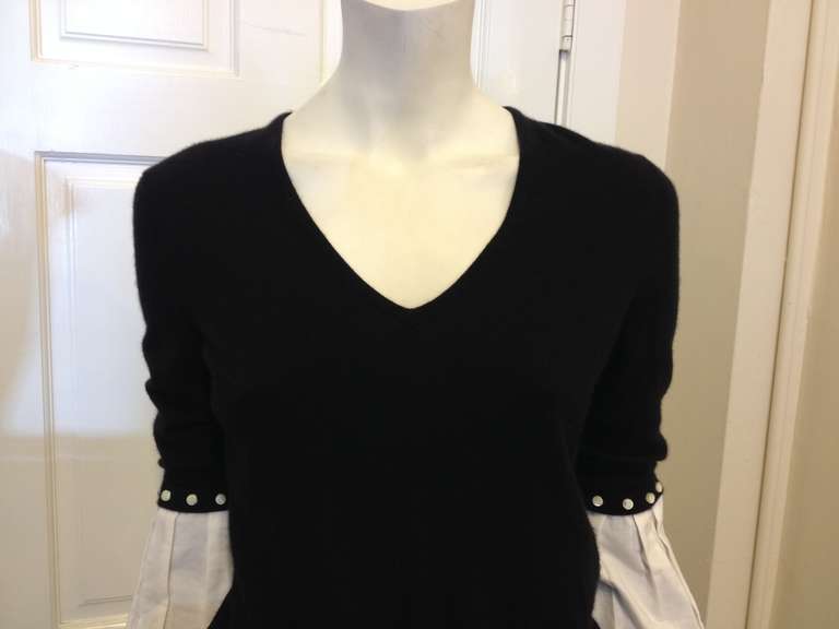 This is a great twist on the classic style.  The black cashmere sweater has voluminous white cotton sleeves that start at the elbow and gather at the wrist.  Pearly buttons attach the white sleeve to the sweater and can be removed if you prefer a