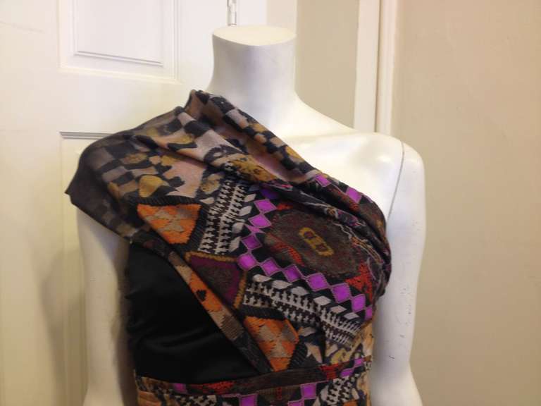 This tribal Etro top is a gorgeous combination of elegance and bohemianism.  The bright violet color pops against the earth tones used in the print.  The bodice fits like a strapless top with ruching along the side zip, and the beautiful loop of