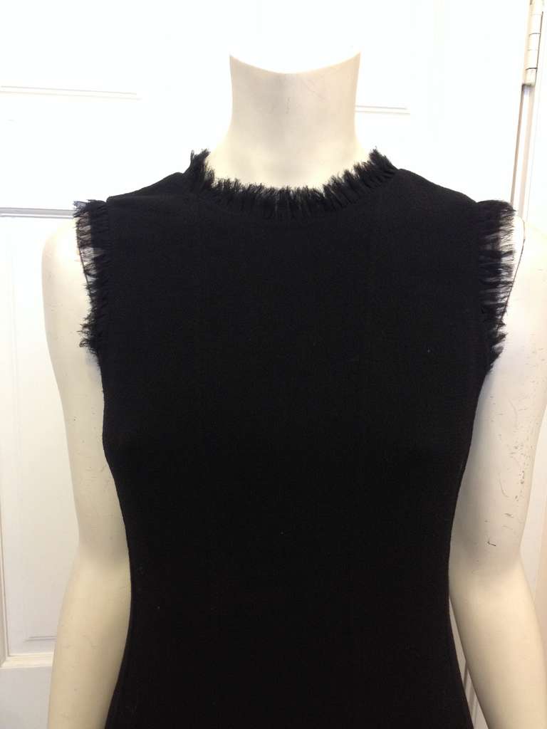 This Oscar de la Renta is the perfect cocktail dress! Timelessly beautiful, classically feminine, and gorgeously constructed, this piece will be a standout look every time. The black wool crepe material is lined at the neck, arm holes, and hem with