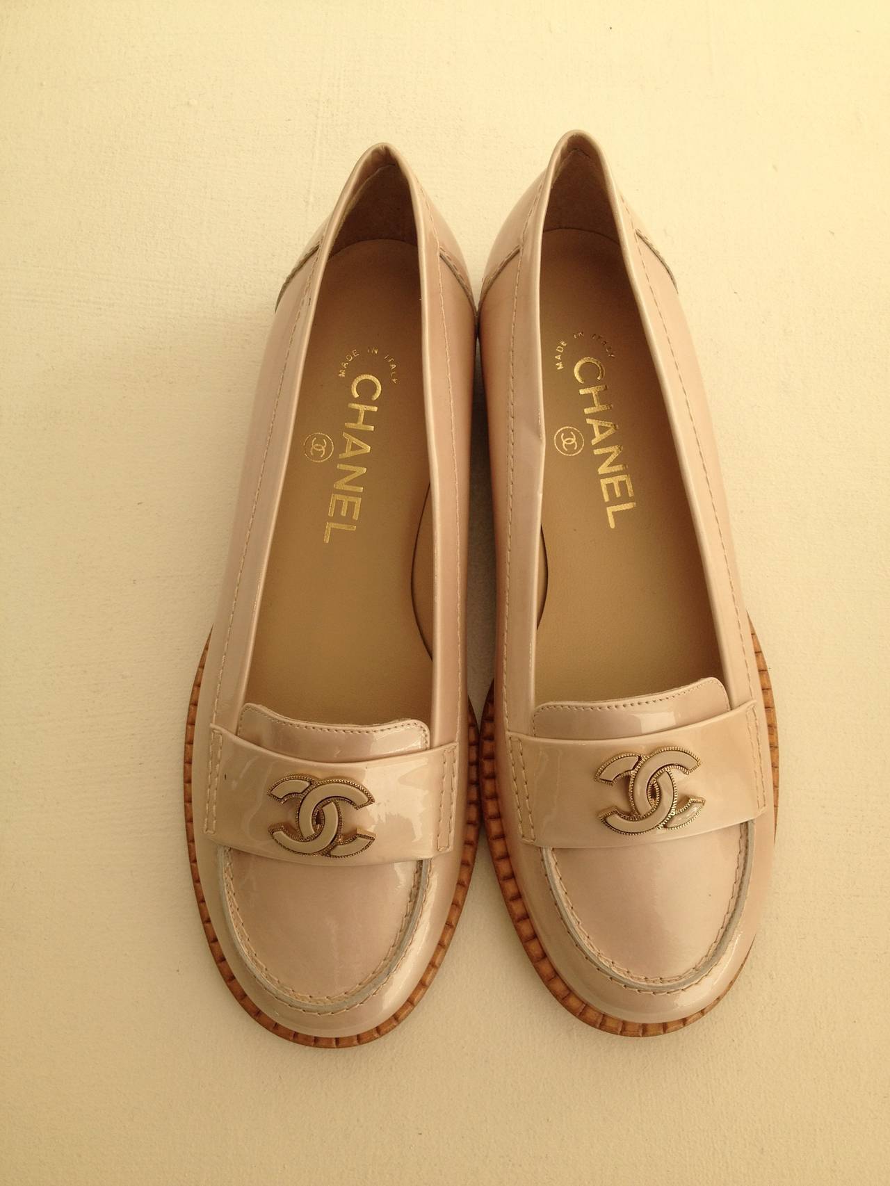 Add a classic touch to your wardrobe with these patent Chanel loafers, which feature an iconic monogram on toe and 0.75 inch heel. Keep up to speed in comfort and style with the high quality sole and pearly finish. An amazing addition to your shoe