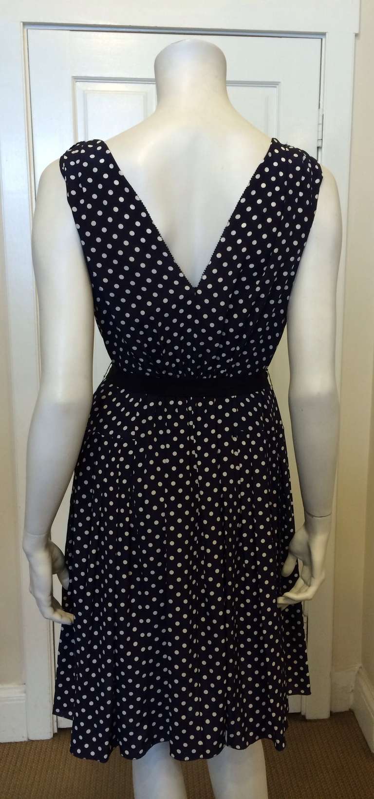 This polka dot Prada dress hits all the right spots! Classic and pretty, this piece is perfect for a picnic in the park, a weekend lakeside getaway, or a lunch out with your friends. With a gathered bodice, v-neck, v-back, full skirt, and ribbon