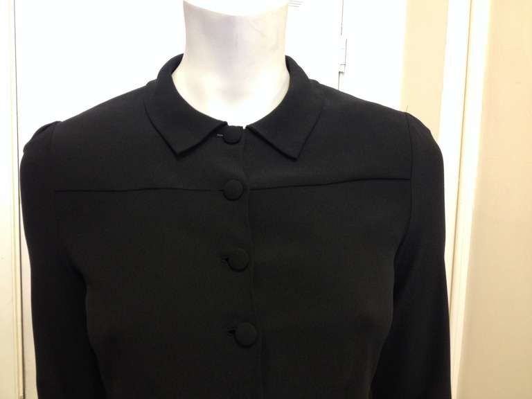 If the perfect tailored black blouse really exists, then this is certainly it. With a delicate pointed collar, covered fabric buttons down the front, and long cuffed sleeves, it's classic and timeless, feminine and pretty. The darts at the ribs and