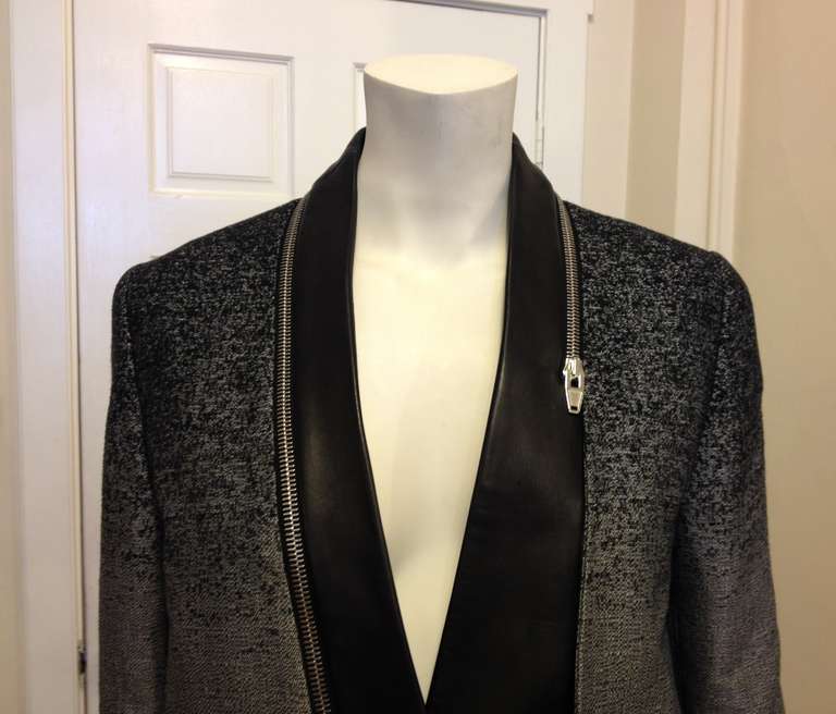 This blazer is a beautiful piece! Striking and sleek, the contrasting lines, angles, and gradients create an ultramodern effect. The grey overlay is silver through the body but speckled with black on the shoulders, and hits right at the hips, while