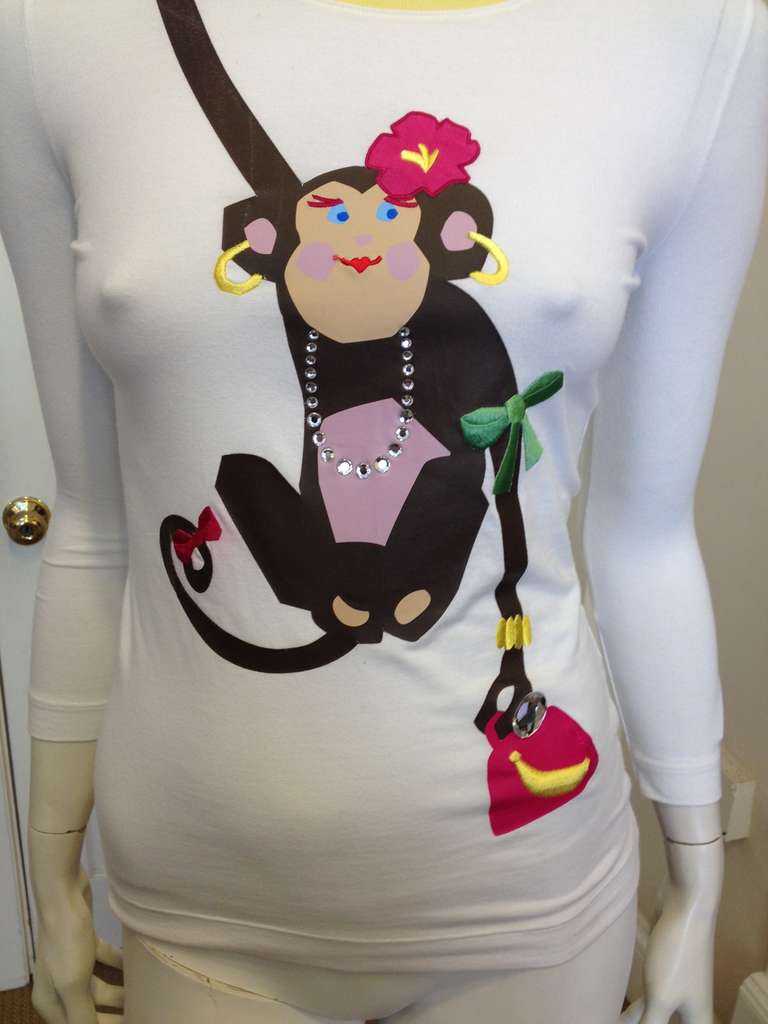 Monkey see, monkey do - and this one must have seen you getting all dolled up! This adorably fabulous little creature is looking her best with a hot pink hibiscus flower behind her ear, a rhinestone necklace on, gold hoop earrings, and a gold cuff.
