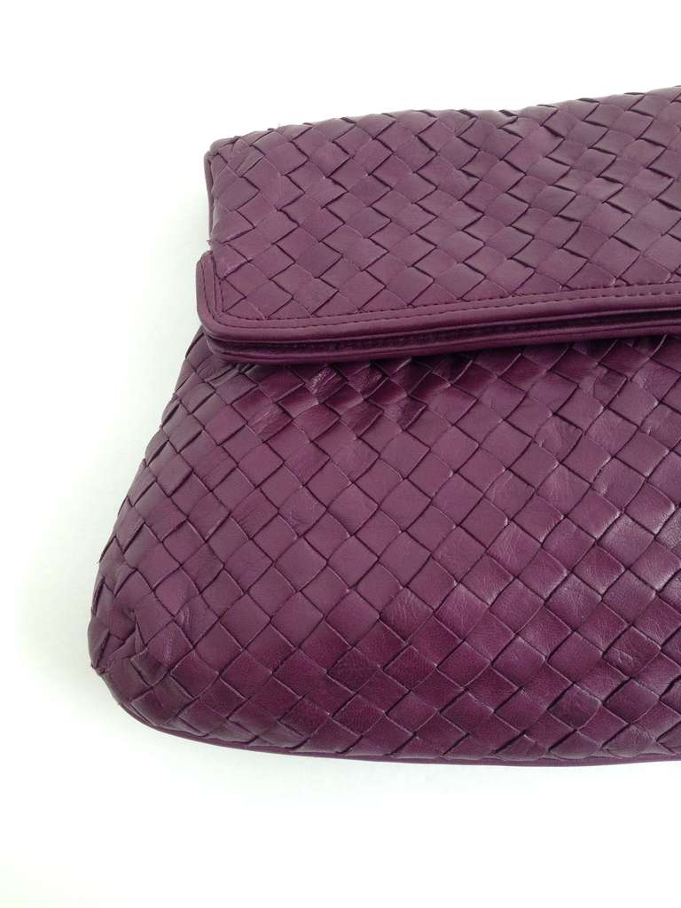 This gorgeous plum leather clutch is the perfect Bottega Veneta piece. Saturated but subtle, the jewel-toned color is appropriate in any season, while the gentle gathering at the fold of the bag creates just the right amount of shape. The natural