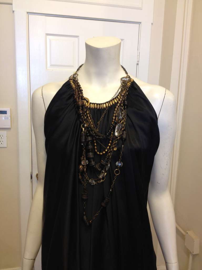 Don't worry about losing your jewelry, this Kaufmanfranco dress has it all built in! This gorgeous piece comes with a detachable necklace that clips onto rings on either side of the front. The chain halter creates the illusion of the top being held