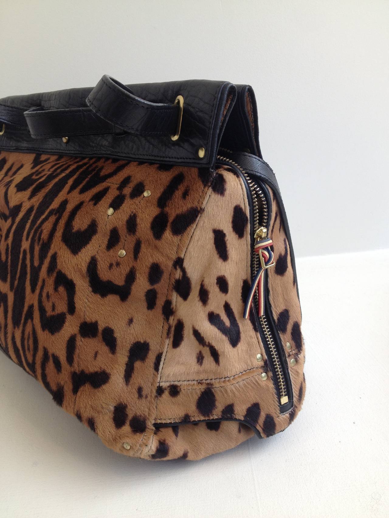 This easy handbag in leopard print pony hair is the perfect way to kick up your look - the interior is spacious and holds everything you need for the day, while the snaps at the top are secure without being too difficult to get into while the strap