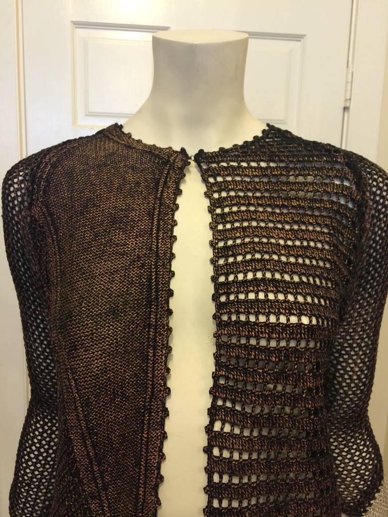 This jacket is a collage of beautiful elements - a mixture of looser lattice knits, bumpier crochet-like knits, and tighter opaque knits is treated with a bronzy rose gold coating to create an organic, inventive look. Panels of silver chain mail