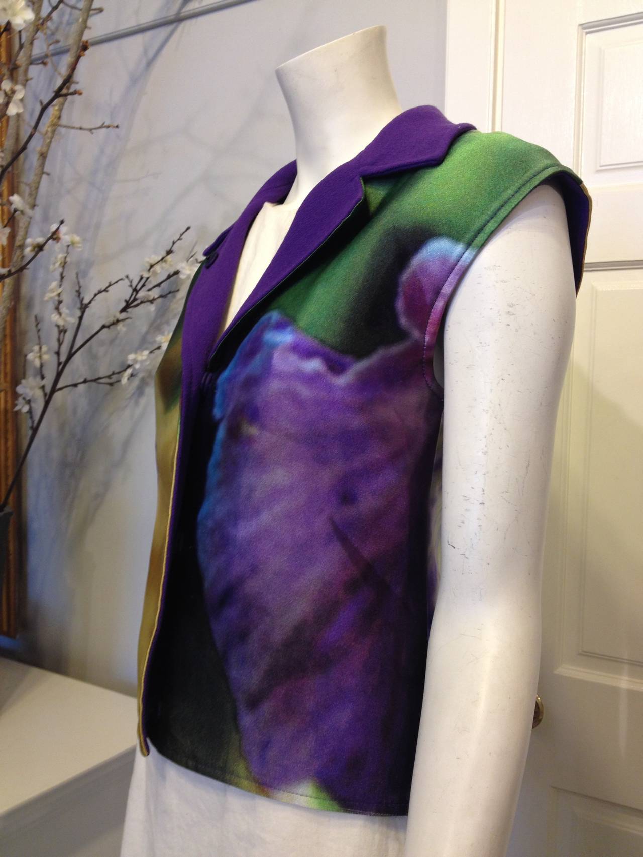 Covered in a sweeping, dreamy, marvelous floral print in shades of emerald, royal purple, warm flax gold, and magenta, it's the perfect vest for any event this year. The backing is a gorgeous deep purple textured fabric, while the outer panels are