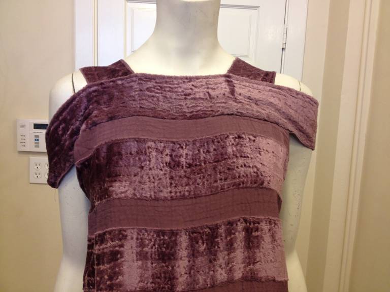 This Bottega Veneta dress is eye catching in its simplicity - crushed velvet bands drape across the body, interspersed with bare lavender stripes. The dress features two straps, and a second band that falls off the shoulder to create an easy and