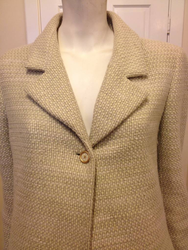 Subtle, creamy pistachio green and super clean tailoring look incredible on this Chanel coat - the color is complex and unusual, while the single button closure, crisp notched lapels, and gentle A-line shape are elegantly simple. From the Autumn