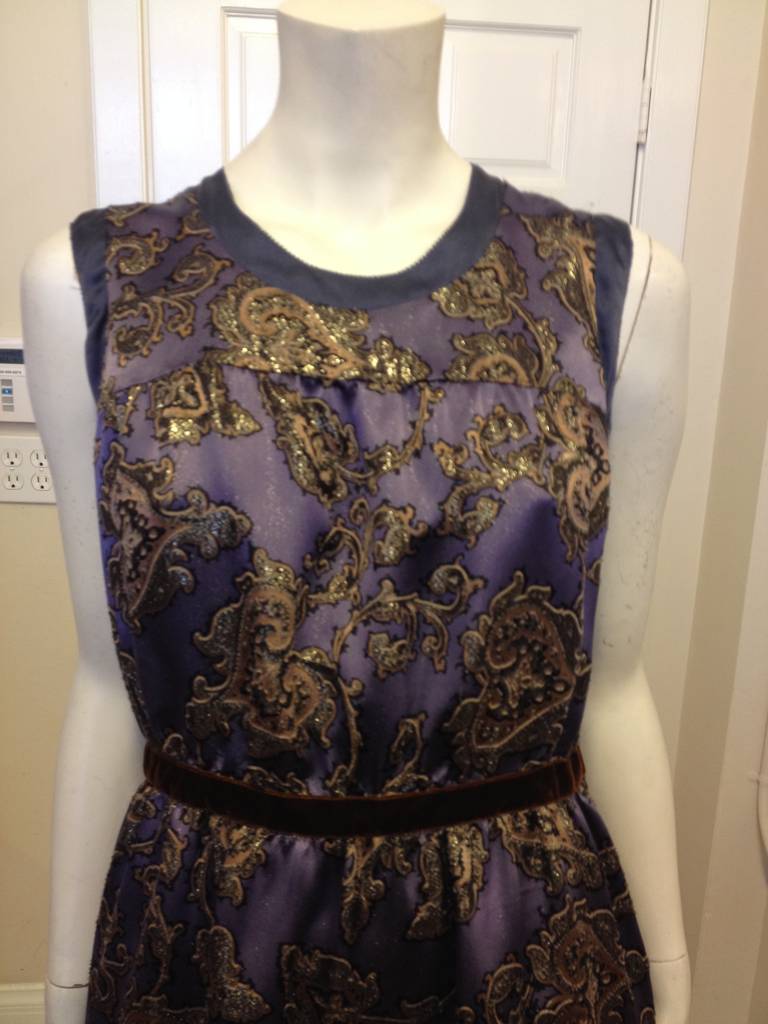 Etro's characteristic paisley gets the royal treatment with this dress. The material is opulent and ornate - gold lurex makes the paisley glimmer, while the lilac satin gleams beneath the design. The simple, chic silhouette is cinched at the waist