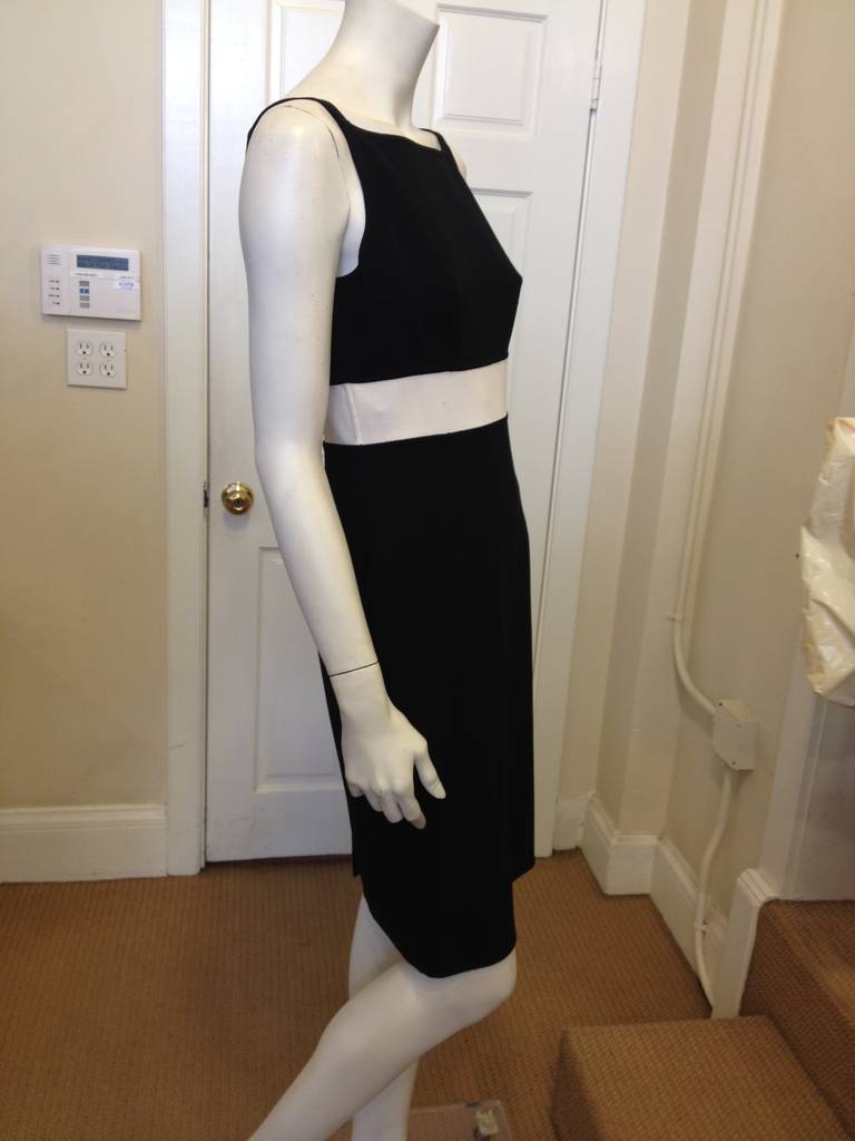 We love the clean simplicity of this Michael Kors dress - the wide squared-off boat neck front and the deep V in back add a 40s inspired glamor to the look.  The white high waistband punctuates a slender shape and long torso. This dress is a great