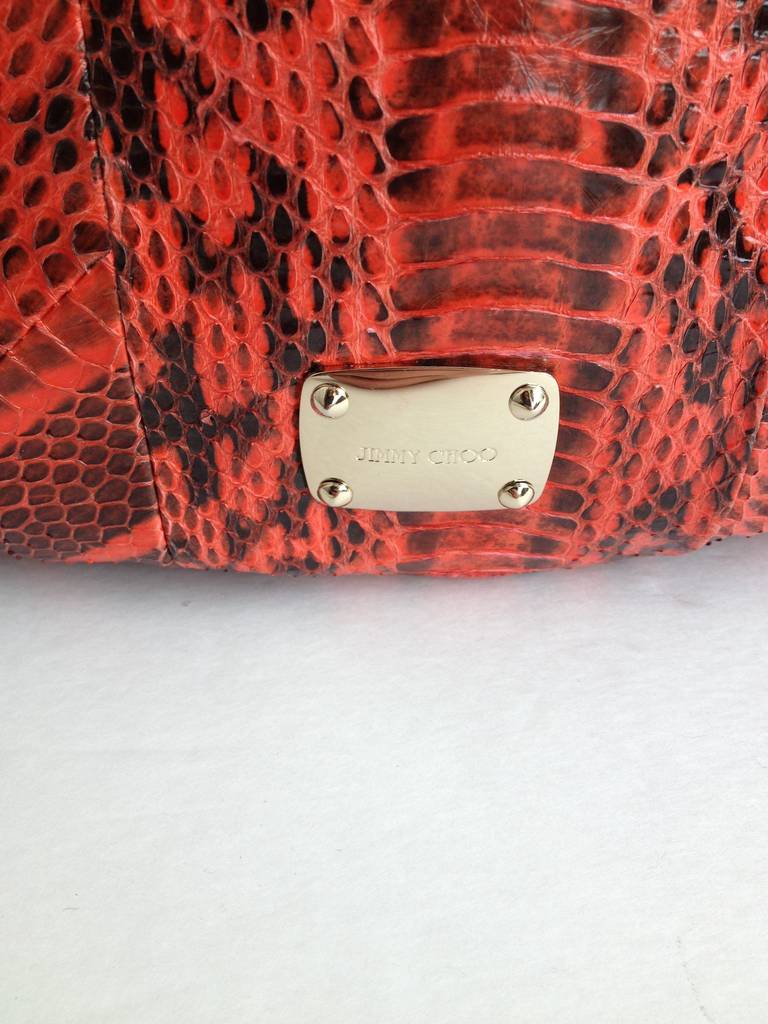 This wild bag is something else - bright red real snakeskin is bold and exotic, while a chunky black bangle on the strap acts as a fun embellishment. The roomy interior is perfect for carrying all your daytime essentials - it's even big enough to