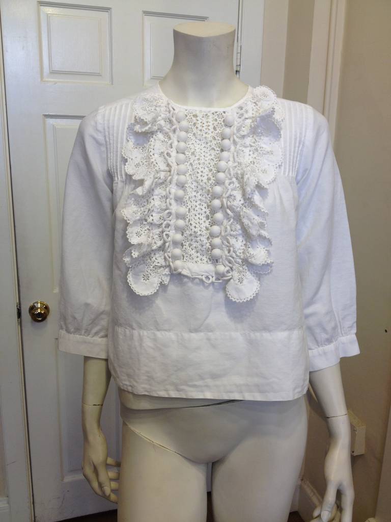 This top captures the Chloe essence perfectly! Loose, breezy, and carefree, it is simultaneously chic and effortless. The front is trimmed with a crochet lace placket, adding a bohemian and feminine flair. The easy cut is perfect for an active and