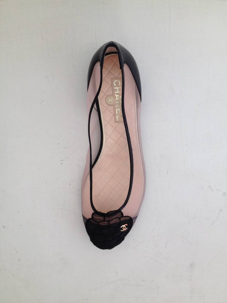 A sheer beauty! These Chanel flats are gorgeous in transparent blush pink mesh. The toe is decorated with a tulle camellia applique and a gold double C charm, while the heel is reinforced with leather. The heel is half an inch. This modern update to