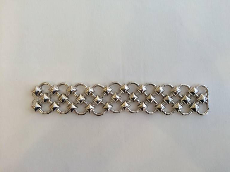 Nothing adds a more luxurious  touch than a piece by Hermes. This particular bracelet is the epitome of chic. The understated silver is beautiful, and the fluid lattice shape is both elegant and edgy. It is constructed with a mesh of links - little
