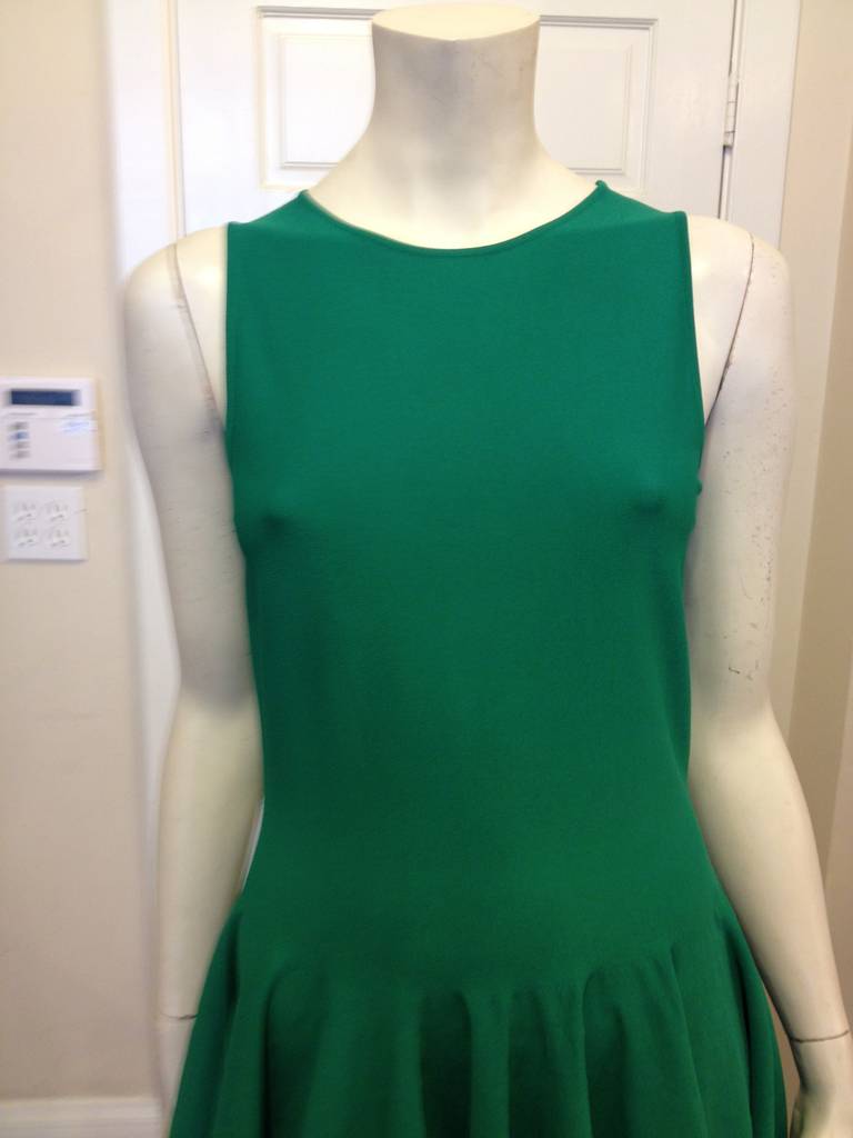 Such a beautiful and easy McQueen dress! The bright emerald green is modern and fun, while the glossy elastic straps ensure a snug and flattering fit. The cut and construction of the piece are clean enough to balance the full skirt. Worn to work