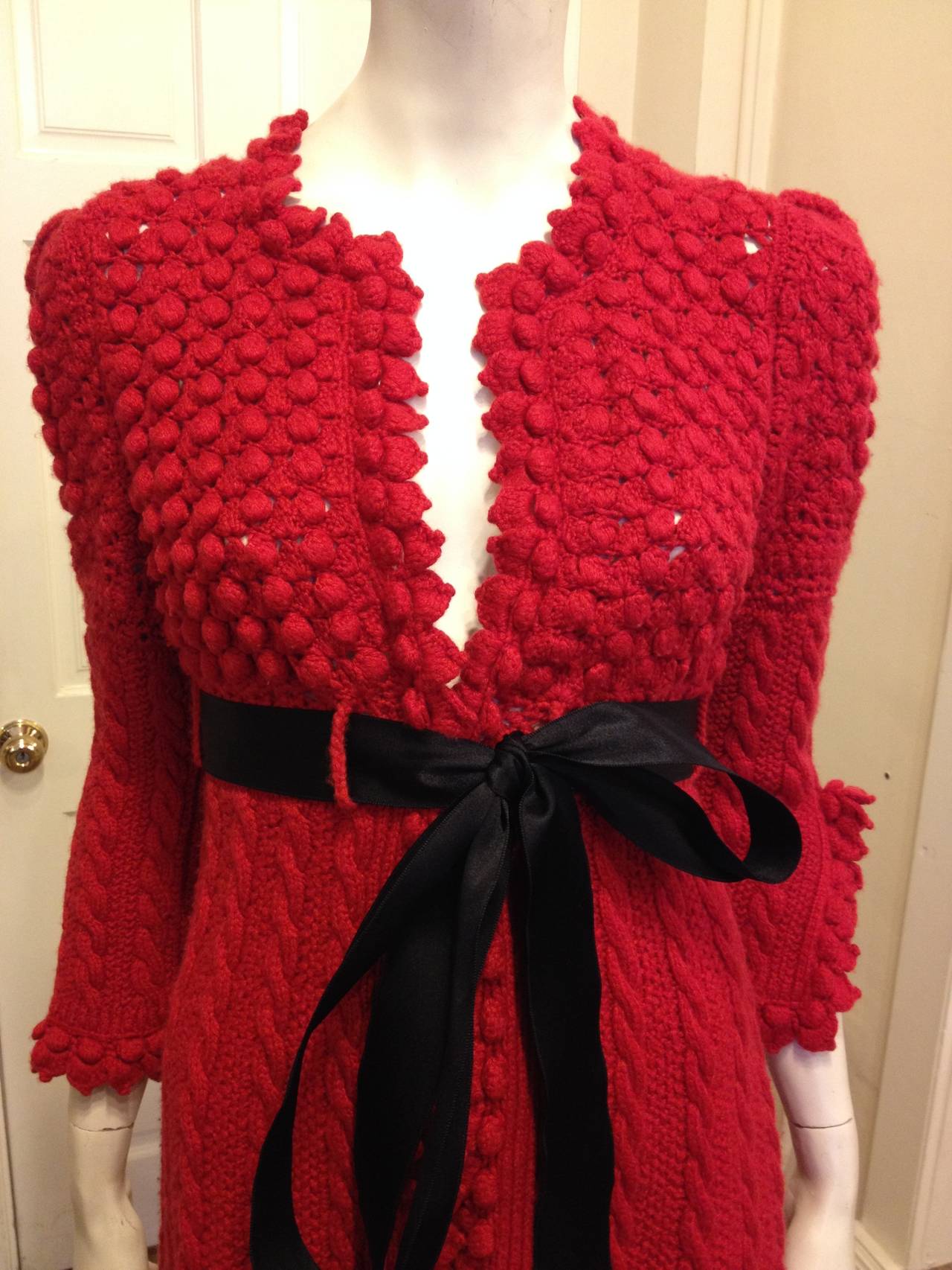 Wear this piece all winter long to show your holiday cheer even if you might want to wear this gorgeous Oscar de la Renta cardigan all year round. The popcorn knit across the chest and back adds a fun, playful touch, while the cable knit skirt is