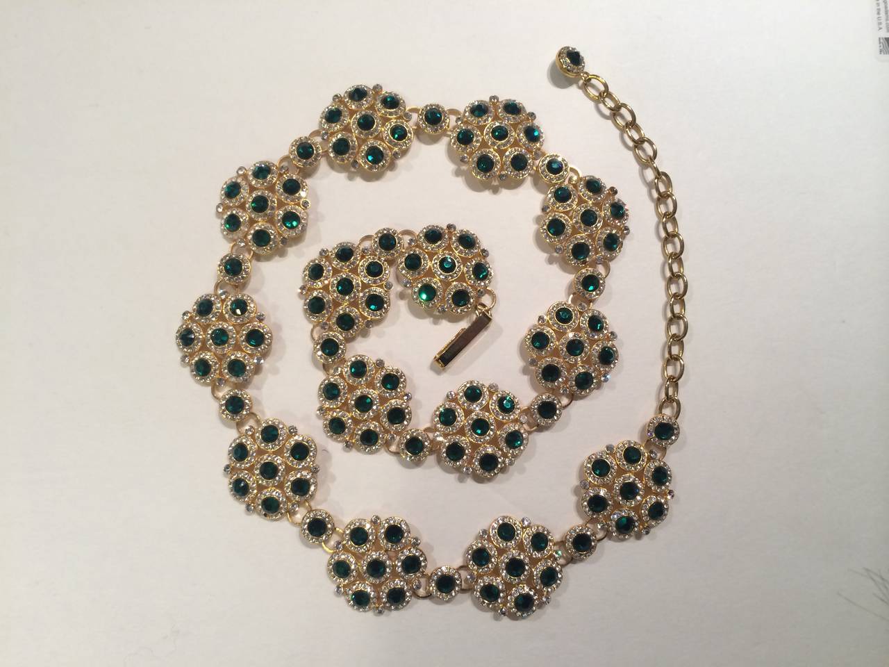 Channel the most fabulous Italian queen in this incredible belt. Medallions with seven green rhinestones surrounded by small clear rhinestones set in gleaming gold-toned metal create an opulent and regal look - the perfect accent to amp up any
