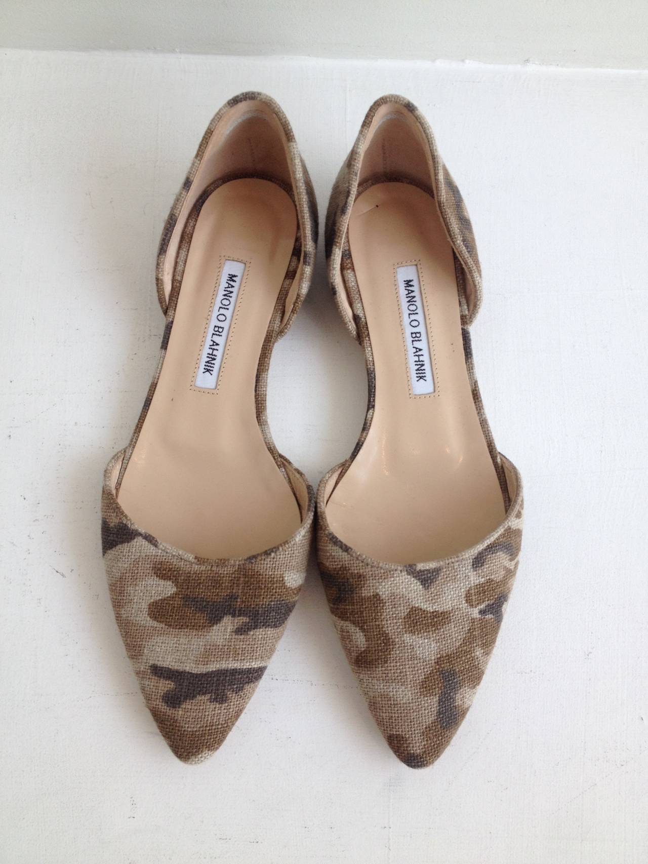 Though these Manolo Blahnik flats keep a low profile with a light beige toned camouflage pattern, they can't help but stand out amid the crowd. The d'Orsday cutout profile and half inch heel are sleek and subtle, and great for wearing everyday,