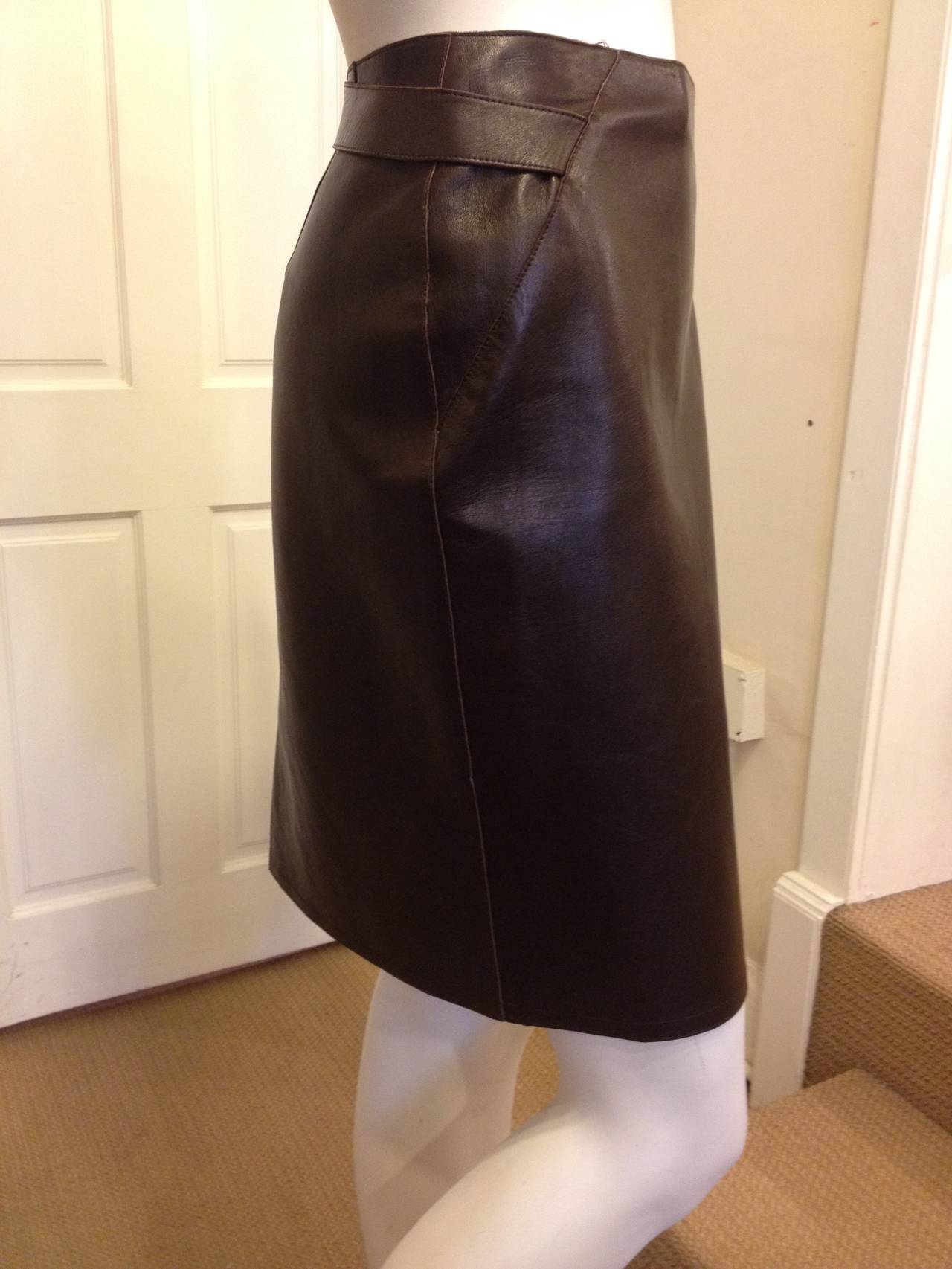 Soft, supple leather makes this Chanel skirt one of our favorites for this season.  The chocolate brown leather straps meet in the back and button with a single pewter button.  The front has a hidden clasp to ensure proper closure.  Perfect for