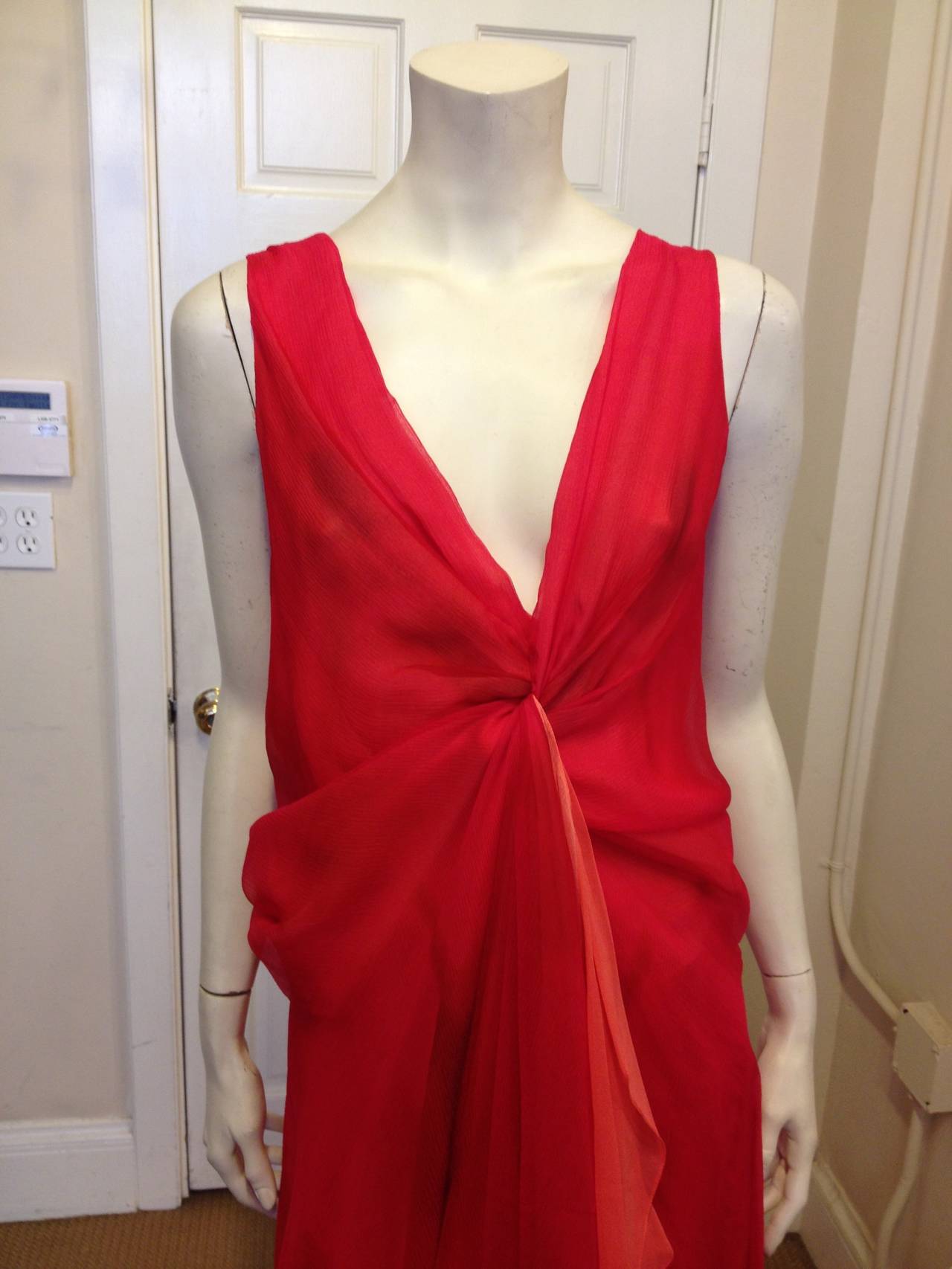 This stunning  Donna Karan dress is just the perfect piece for a formal event or beach getaway. Multiple layers of chiffon meet in the front and form a twisted knot at the base of a deep V, and they do the same in the back.  Two extra long petals