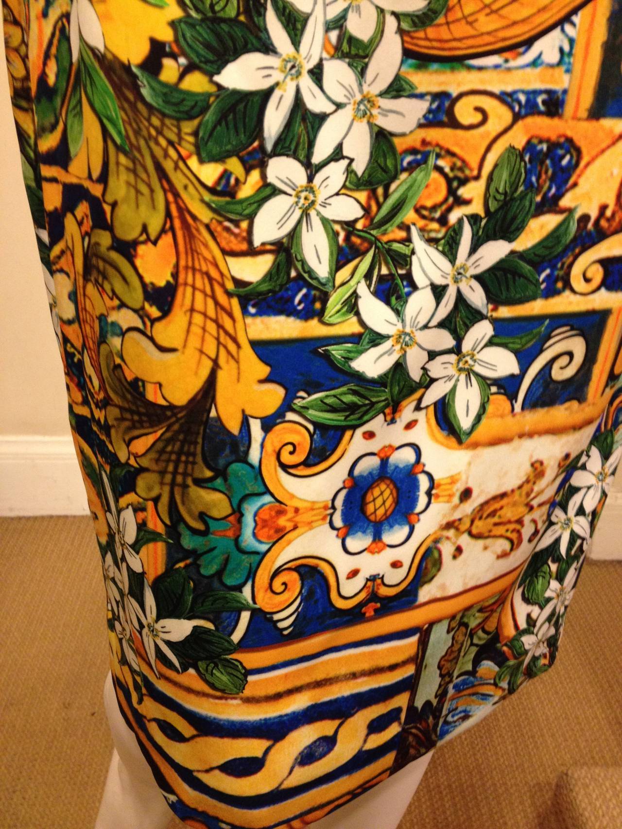 You can almost smell the jasmine from this fabulous skirt - super bright, deeply saturated colors dance across the piece, forming a cacophony of flowers and deep emerald green leaves blossoming over a golden yellow and royal blue mosaic pattern.