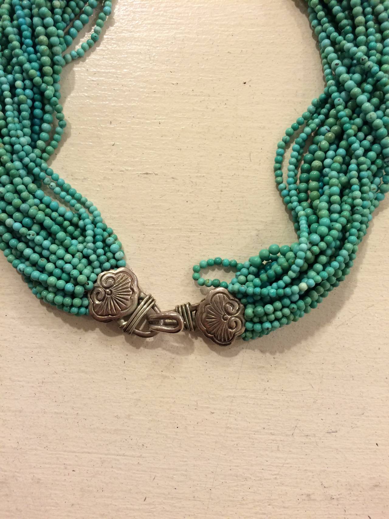 Turquoise and silver are a timeless combination. Evoking the Southwestern landscape, this necklace is like a precious heirloom - the pendant is even signed by the artist, as seen in image four. Multiple strands of turquoise seed beads form a collar