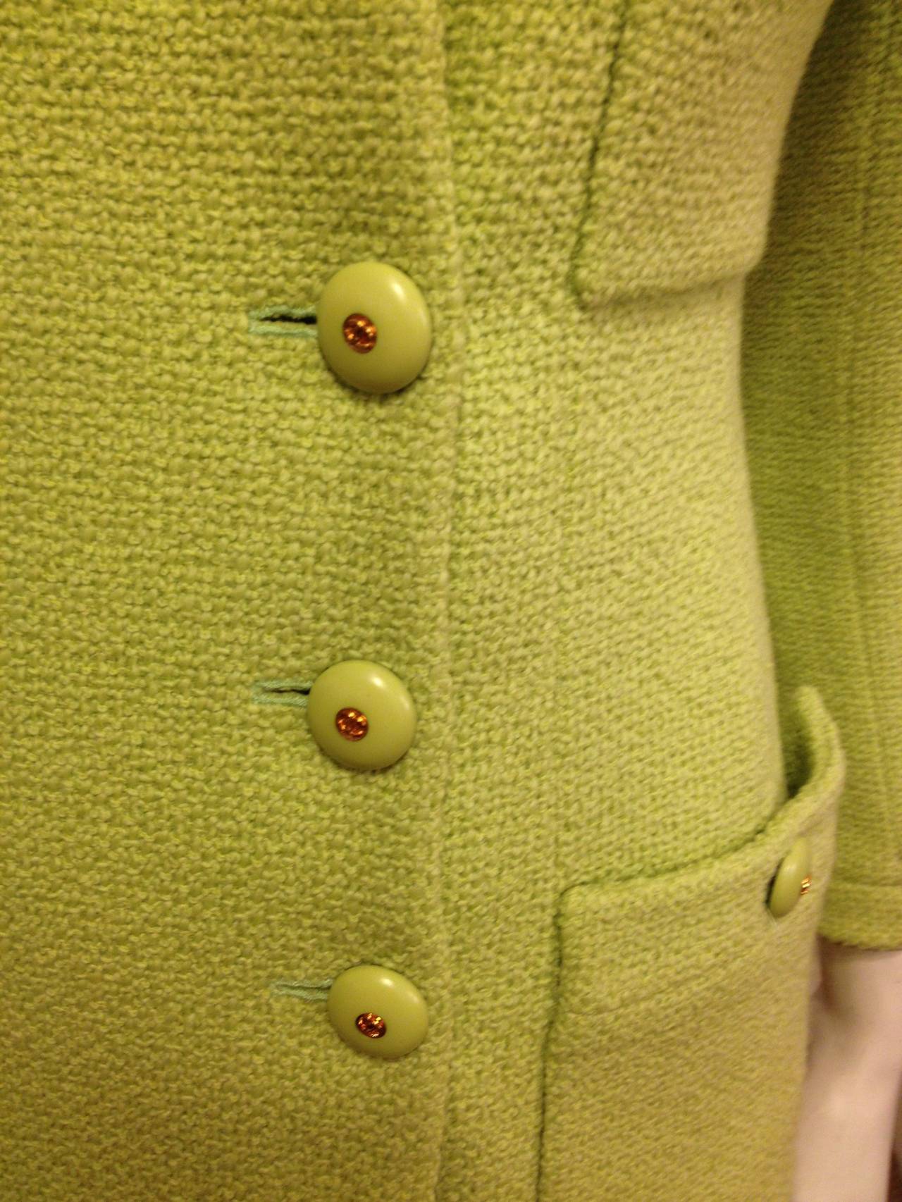 Stand out from the crowd! This Chanel bright green jacket is bold and fun with a pop-art sensibility. The deep scoop neck is modern and easy, while the four front pockets add symmetry to the design and add a useful element. Six rhinestone buttons