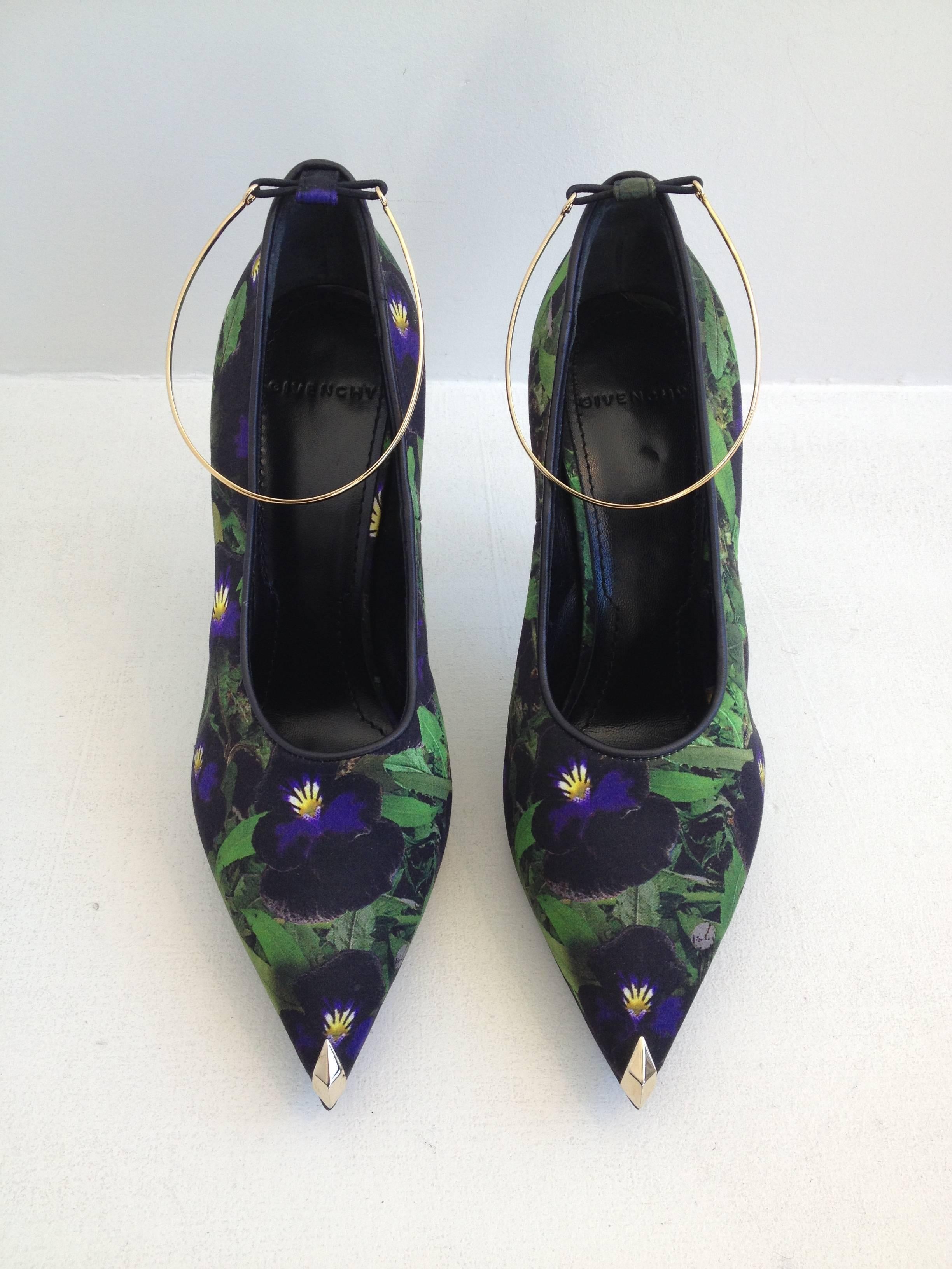 Elegant and unexpected - these Givenchy heels are just beautiful. The pointy toe is equipped with a small hidden .5 inch platform, while the body of the shoe is covered in a gorgeous black satin printed with a dark and mysterious nighttime foliage