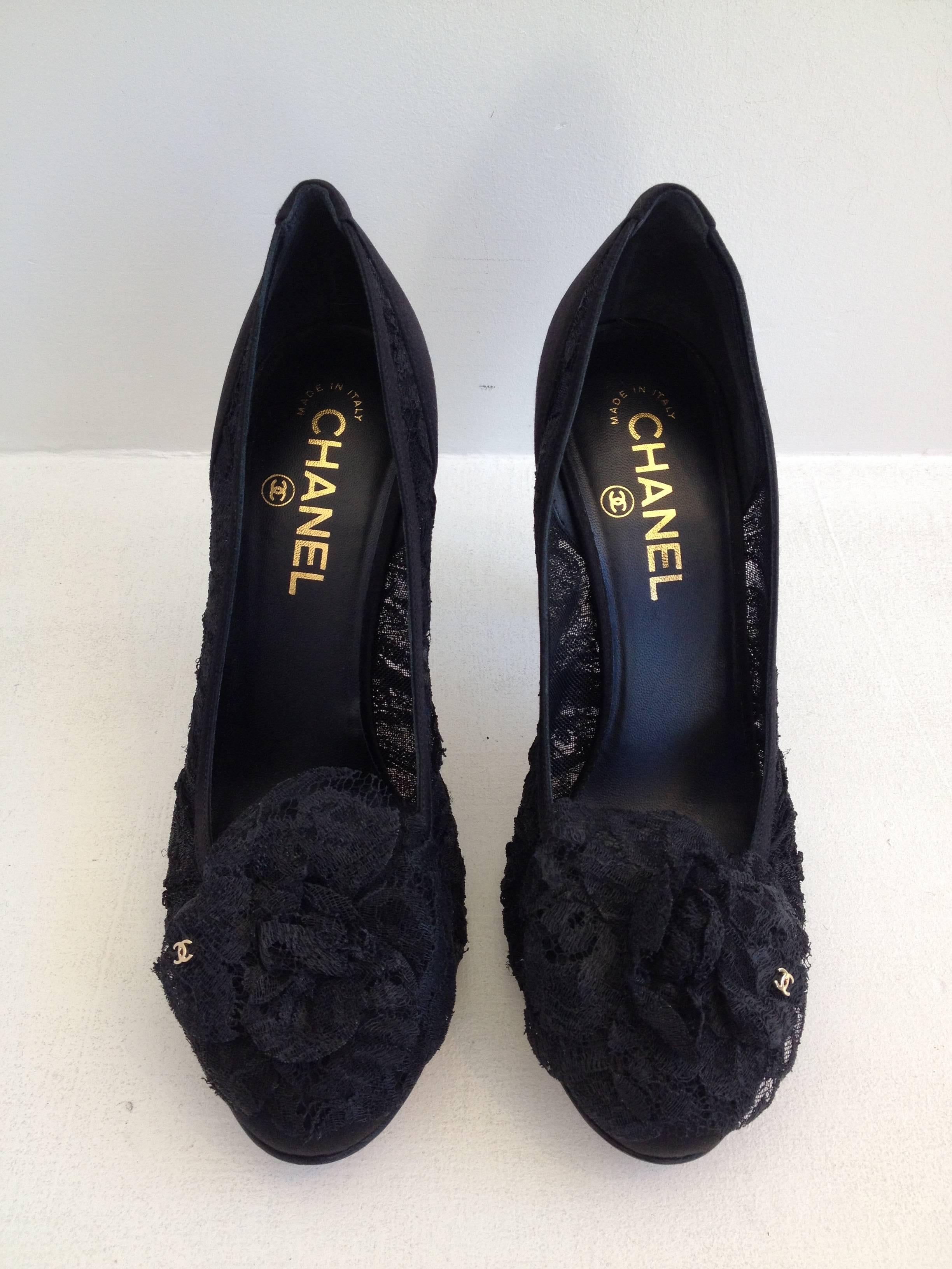Delicate and feminine lace makes this pair of classic Chanel pumps truly exquisite. The toe is decorated with an iconic camellia made from the same black lace, which is adorned with a gold double C logo. These are a perfectly timeless pair of heels