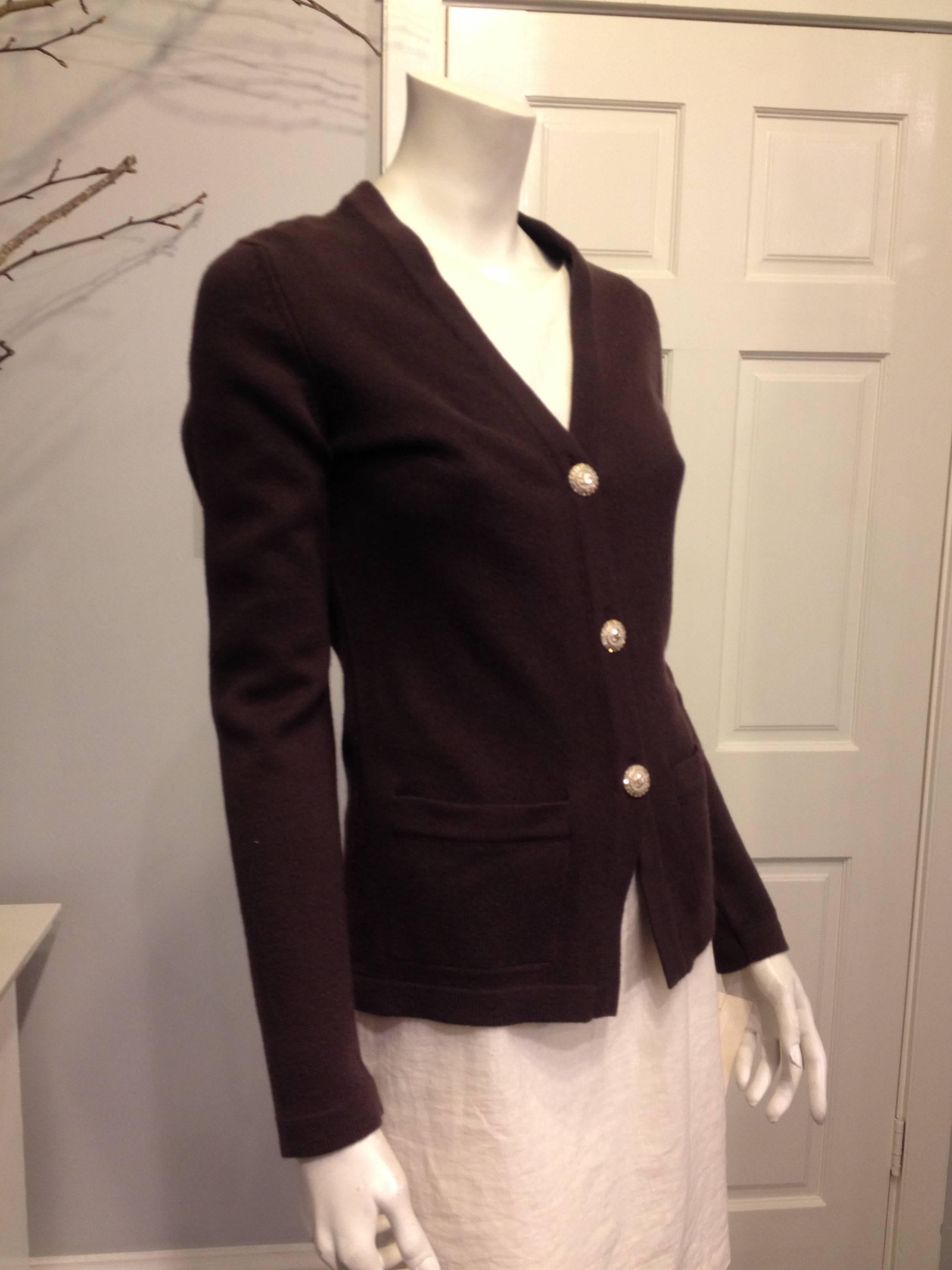 There's nothing more perfectly easy than a cashmere cardigan from Chanel. Dark chocolate brown is casual and versatile, while the rhinestone double C buttons add a dressy touch. The v-neck, long sleeves, and slim cut body is ideal for layering. A