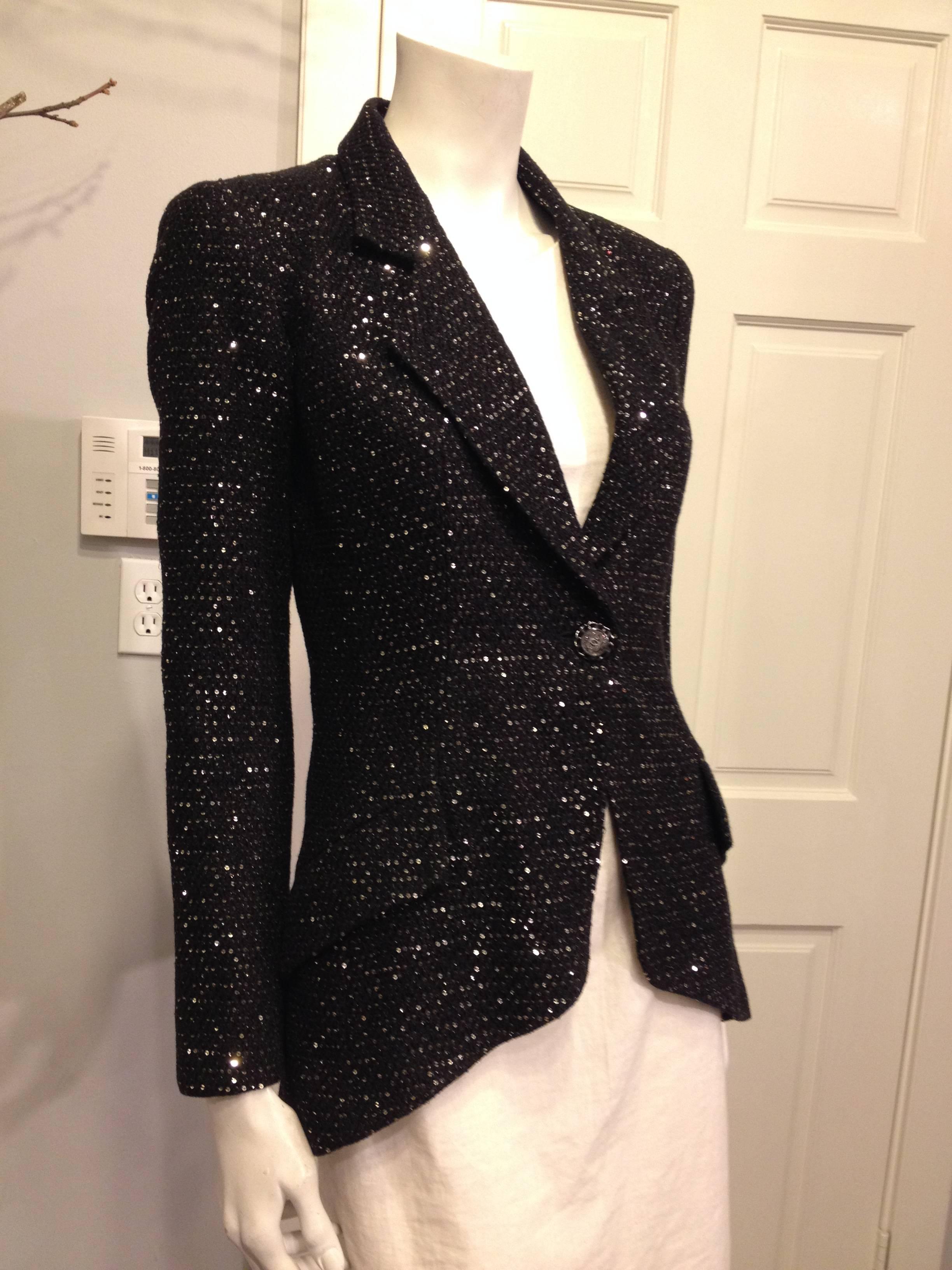 This perfect holiday jacket is cut into a sharp single-button blazer shape with an angled hemline. It is the ideal piece to  wear over your favorite cocktail dress or with a sleek pair of pants at any party this winter. The sleeves are cut into a